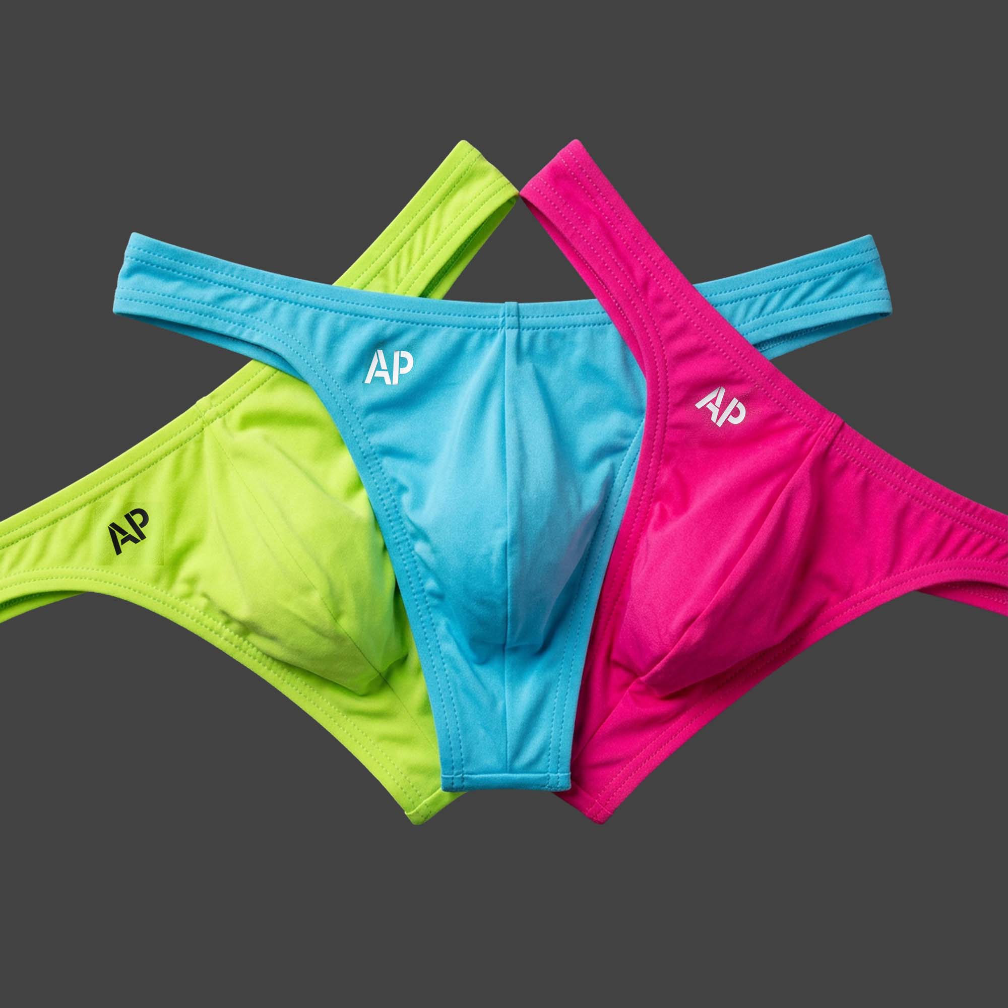 Pack: Pack x3 Tanga CYBER LIME colores verde lima, magenta y celeste. Vista conjunto con las tres piezas en disposición abanico. Alepadron.